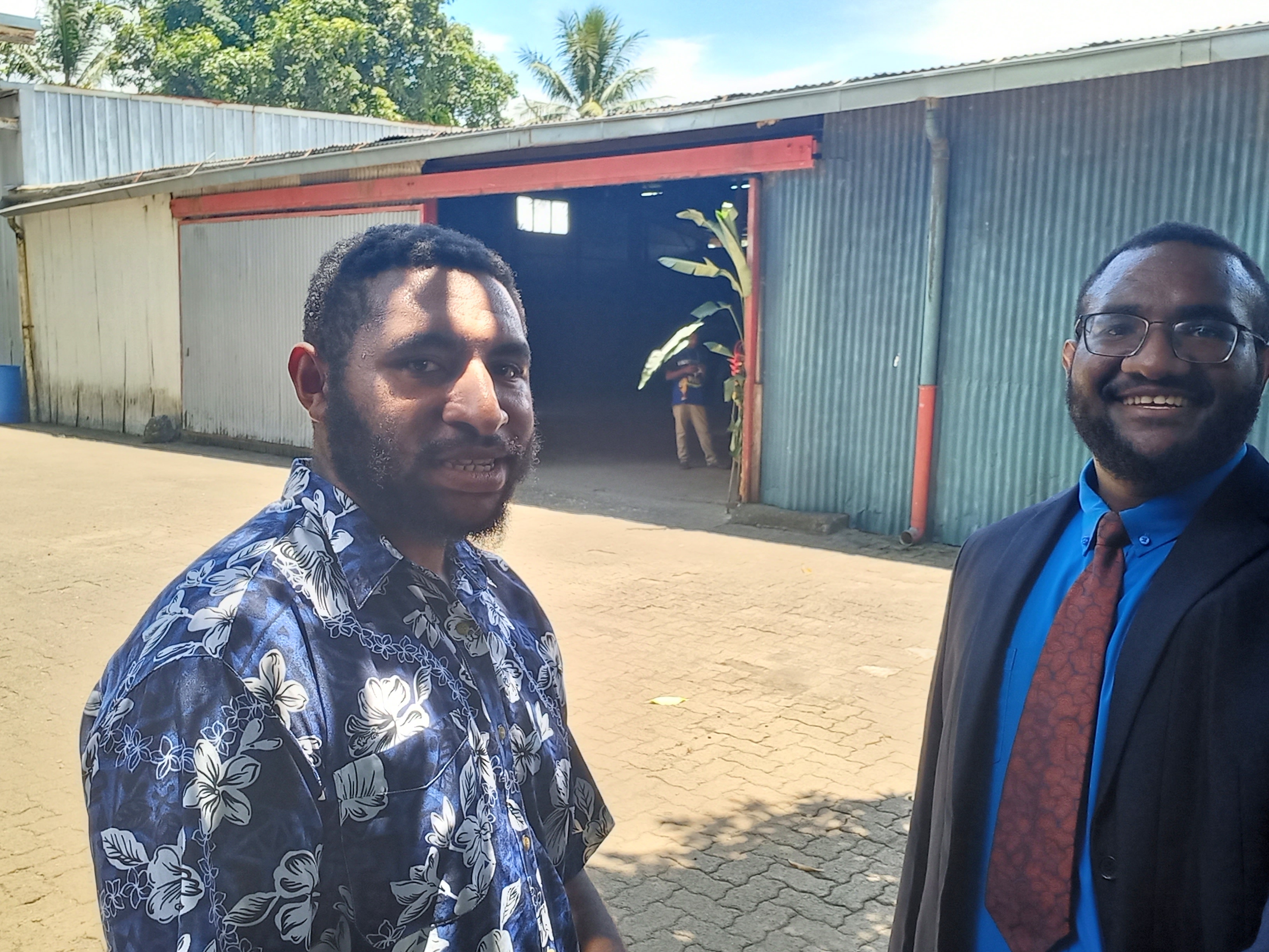 image of joshua junior kingal and his best friend Raynile Wills in front of their church hall