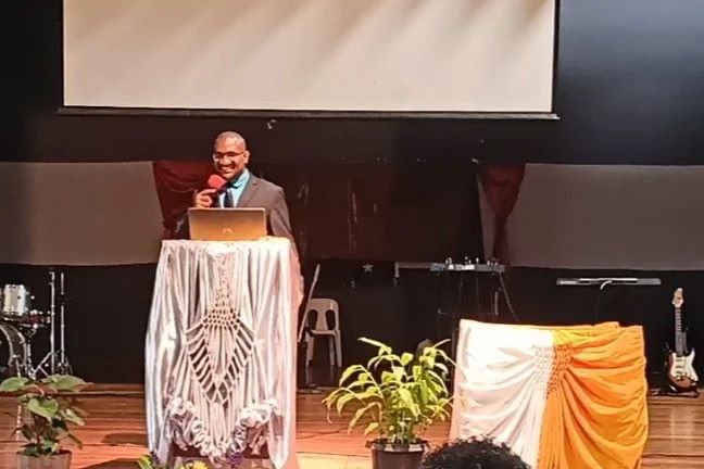 image of joshua junior kingal teaching at a lecture hall