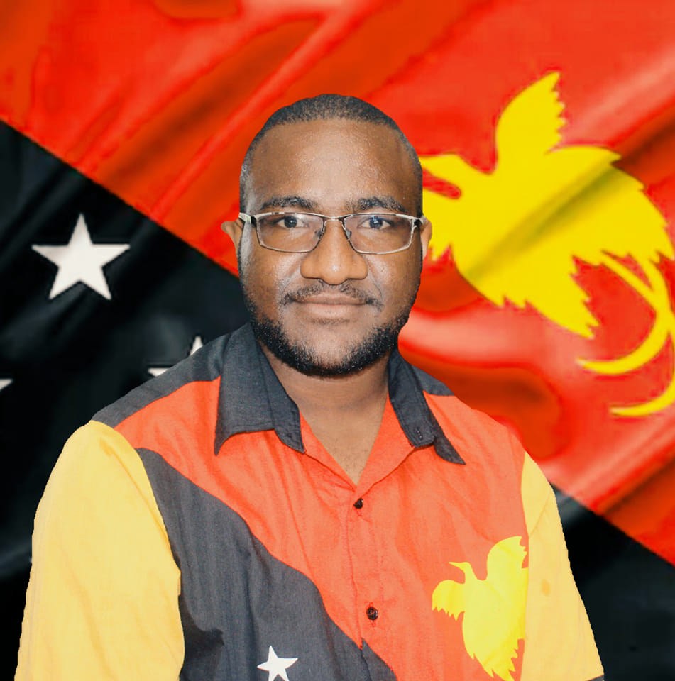 image of joshua junior kingal wearing papua new guinea flag color shirt and in front of a papua new guinea flag colored background